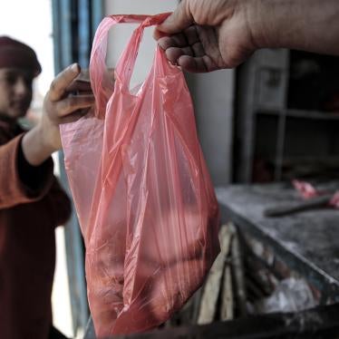 A boy is handed a bag of bread