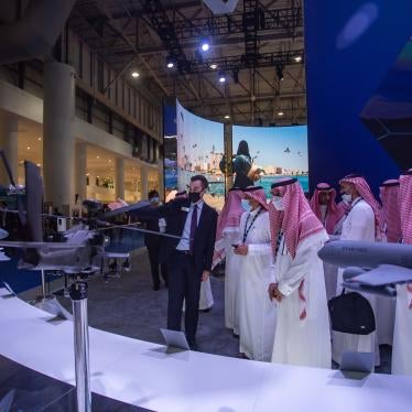 Men examine models of military equipment