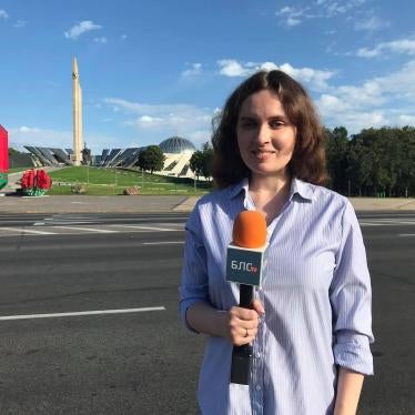 Journalist Katsiaryna Andreyeva is seen holding a microphone reporting for television