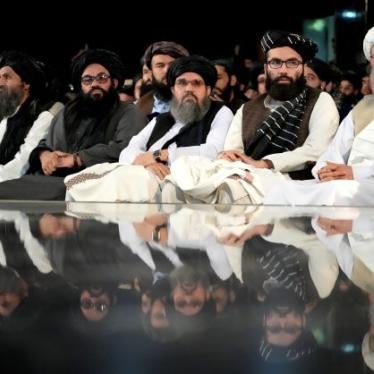 Taliban leaders sit in a row at a ceremony