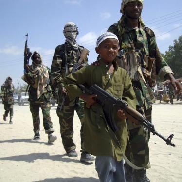 A young boy leads hard-line Islamist al-Shabab fighters in Mogadishu, Somalia. 
