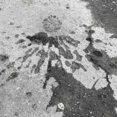 The fragmentation pattern left by an apparent cluster munition impact during an attack on a populated neighborhood in Kherson city 