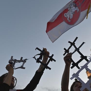 Protesters display broken paper prison bars representing the Belarusian population in prisons and the lack of freedom in Belarus, in Krakow, Poland on August 9, 2022. 