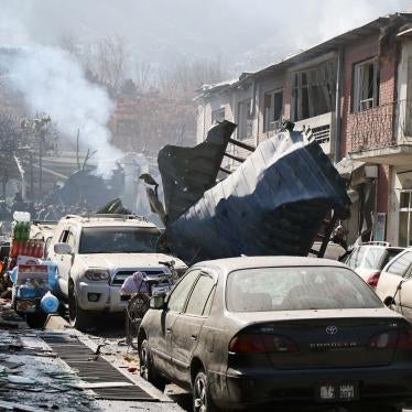 Afghan security officials inspect the site of a Taliban suicide bombing in Kabul.