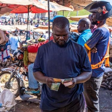 A trader counts out Ghanaian cedi banknotes
