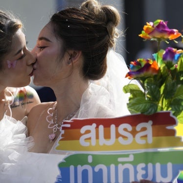 Women kiss while holding a poster to support marriage equality, during a Pride Parade in Bangkok, Thailand, June 4, 2023. ©2023 AP Photo/Sakchai Lalit, File