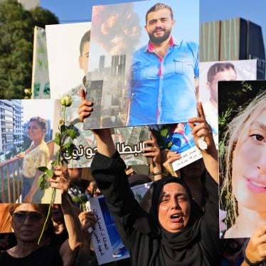 Relatives of victims of the deadly 2020 Beirut port explosion hold portraits of loved ones to mark the third anniversary of the blast, outside the port of Beirut, Lebanon, August 4, 2023. 