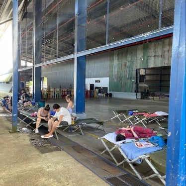 The interior of Costa Rica’s migration reception center in Puntarenas, showing the play area for children behind a row of cots.