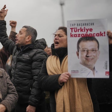 People hold posters of Istanbul Mayor Ekrem İmamoğlu as they protest outside the Vatan Security Department, where İmamoğlu is expected to be taken following his arrest in Istanbul, Türkiye, March 19, 2025. 