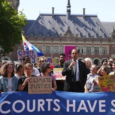 Ralph Regenvanu, Vanuatu's minister for climate change, speaks surrounded by demonstrators at the International Court of Justice ahead of an advisory opinion on what legal obligations nations have to address climate change in The Hague, Netherlands, July 23, 2025.