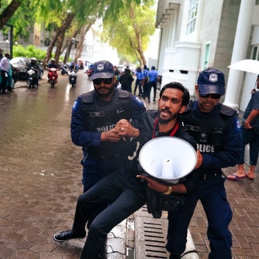 Maldives police detain a journalist during a protest against the Maldives Media and Broadcasting Regulation Bill outside government offices in the capital, Malé, on August 27, 2025.