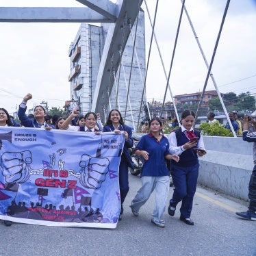 A row of students hold a protest banner which reads "Let's go Gen Z, protest against corruption"
