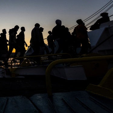 A group of newly-arrived migrants board a ferry in Souda, on the island of Crete, Greece, July 11, 2025.