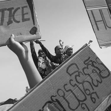 Members of the Boeung Kak Lake community in Cambodia demonstrate at a police blockade in December 2012 on the second day of community activist Yorm Bopha’s trial.