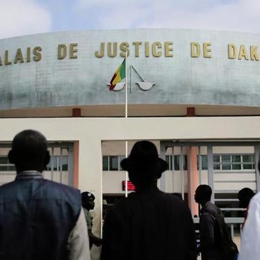Clement Abaifouta, Souleymane Guengueng and Abdourahmane Guèye, stand outside of the courthouse where the trial of Hissène Habré will be held, on July 13, 2015 in Dakar, Senegal. The trial is set to begin on July 20, 2015. © 2015 Human Rights Watch