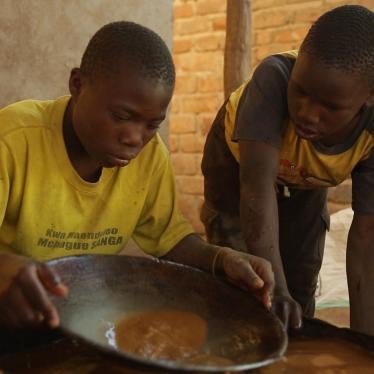 A 15-year-old boy mixes mercury and ground gold ore at a processing site in Mbeya Region, Tanzania