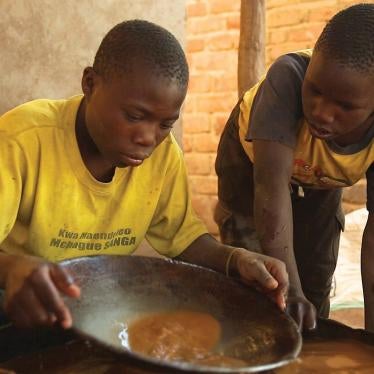 A 15-year-old boy mixes mercury and ground gold ore at a processing site in Mbeya Region, Tanzania. 