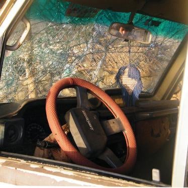 A boy peers into a vehicle damaged in a US drone strike on a wedding procession on December 12, 2013 outside Rad`a, Yemen.