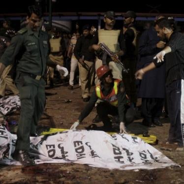 Rescue workers move a body from the site of a blast outside a public park in Lahore, Pakistan on March 27, 2016.