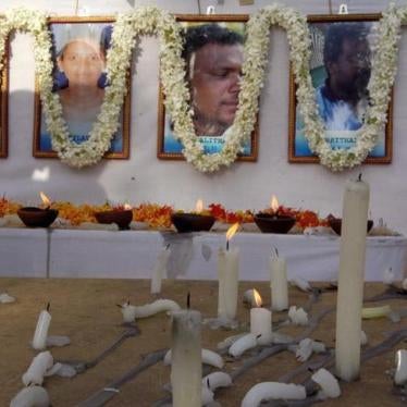 Candles are burned at the memorial for slain humanitarian workers from Action Contre La Faim in Batticaloa, Sri Lanka, August 11, 2006.