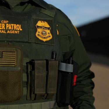 A US border patrol agent walks along the border fence separating Mexico from the United States near Calexico, California, U.S. February 8, 2017.
