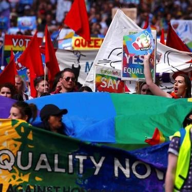 Marchers hold signs and banners as they participate in a marriage equality march in central Sydney, Australia on October 21, 2017.