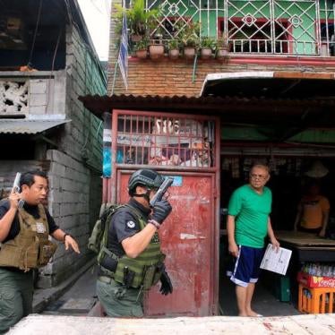 201712asia_philippines_pdea A resident looks at the Philippine Drug Enforcement Agency (PDEA) operatives during their anti-drug operations in Quezon city, metro Manila, Philippines March 16, 2017. 