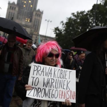 A woman takes part in a rally marking the first anniversary of the “Black Protest” against plans of changing the abortion law, in front of Palace of Culture and Science in Warsaw, Poland October 3, 2017. The poster reads "Women's rights are a condition of