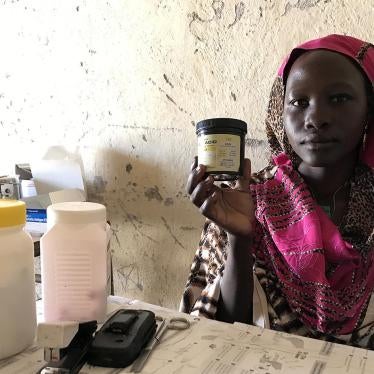 Mukuma Hamad, a volunteer health worker, holds a container of folic acid, the only assistance she can give pregnant women who visit the lone health clinic in Hadara village, in rebel-controlled Southern Kordofan. 