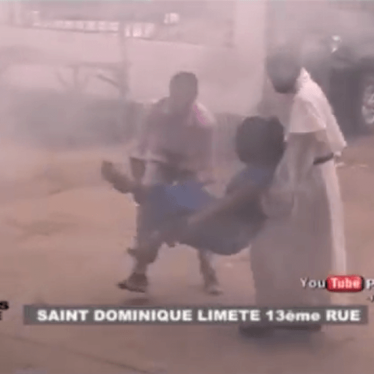 Photo of two people carrying a woman injured in the Democratic Republic of Congo.