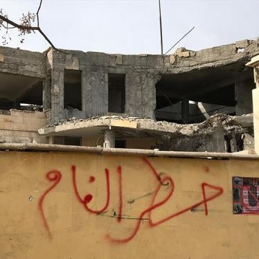 Warning about mines written on outside wall of building in Raqqa, Syria, January 21, 2018.