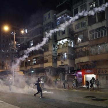 Protesters react to teargas from the Sham Shui Po police station in Hong Kong, August 14, 2019.