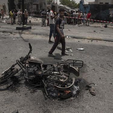 Civilians gather at the site of a deadly attack in Aden, Yemen