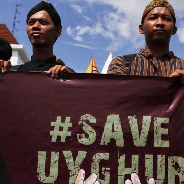 Muslim activists hold a #SaveUyghur poster during a rally in Yogyakarta, Indonesia on December 21, 2019.