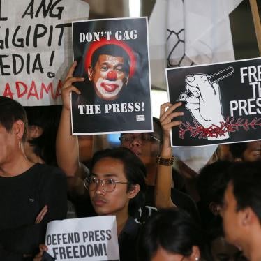Journalists and supporters, wearing black, display their messages during a protest against the recent Securities and Exchange Commission's revocation of the registration of Rappler, an online news outfit, Friday, Jan. 19, 2018, northeast of Manila, Philip
