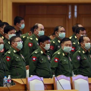 Myanmar military representatives stand during a regular session of the Union Parliament, March. 11, 2020.