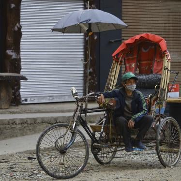 Rickshaw driver with mask on in Nepal 