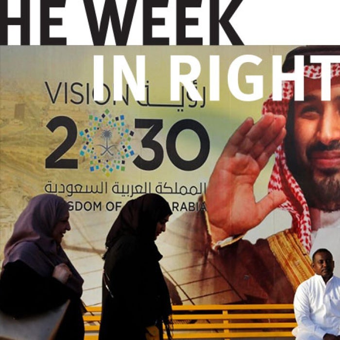  People walk past a Vision 2030 banner showing Saudi Crown Prince Mohammed bin Salman, Jeddah. 