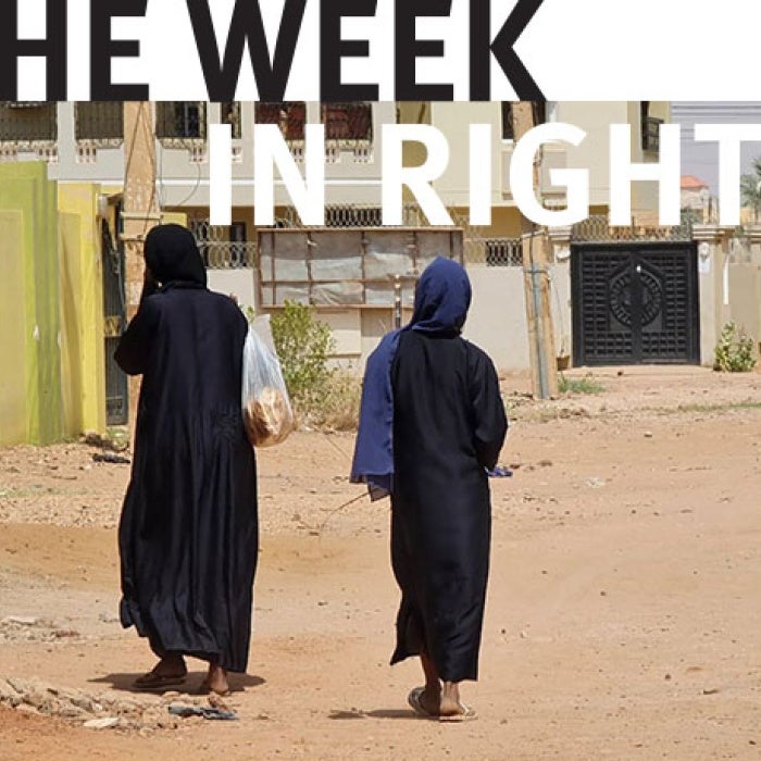  Women walk on an empty street in Khartoum's Jabra neighborhood