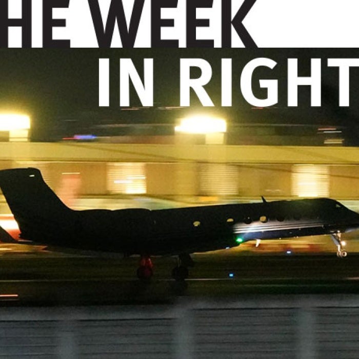 A plane takes off on tarmac. 